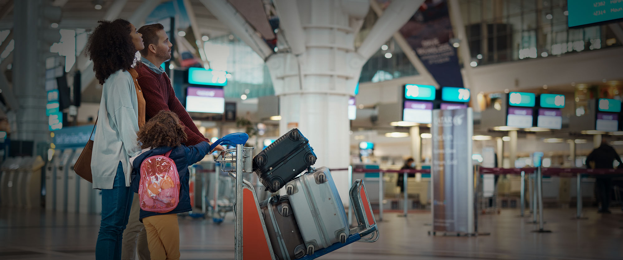 Travelers moving through a busy airport terminal